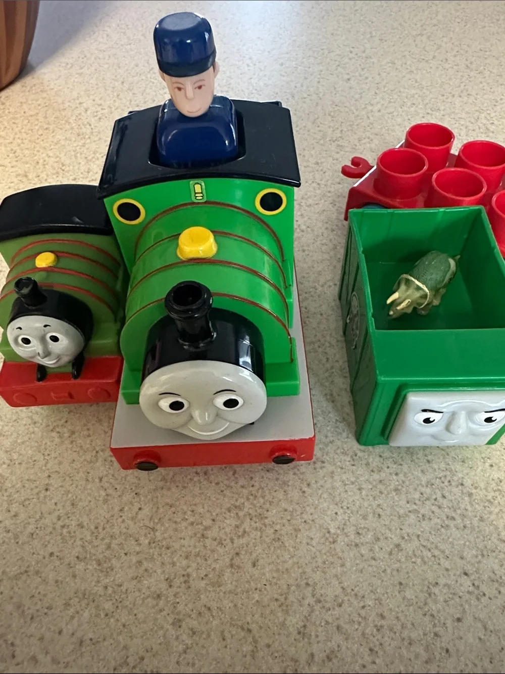 Green Percy the Small Engine toys and cargo cars from Thomas & Friends.